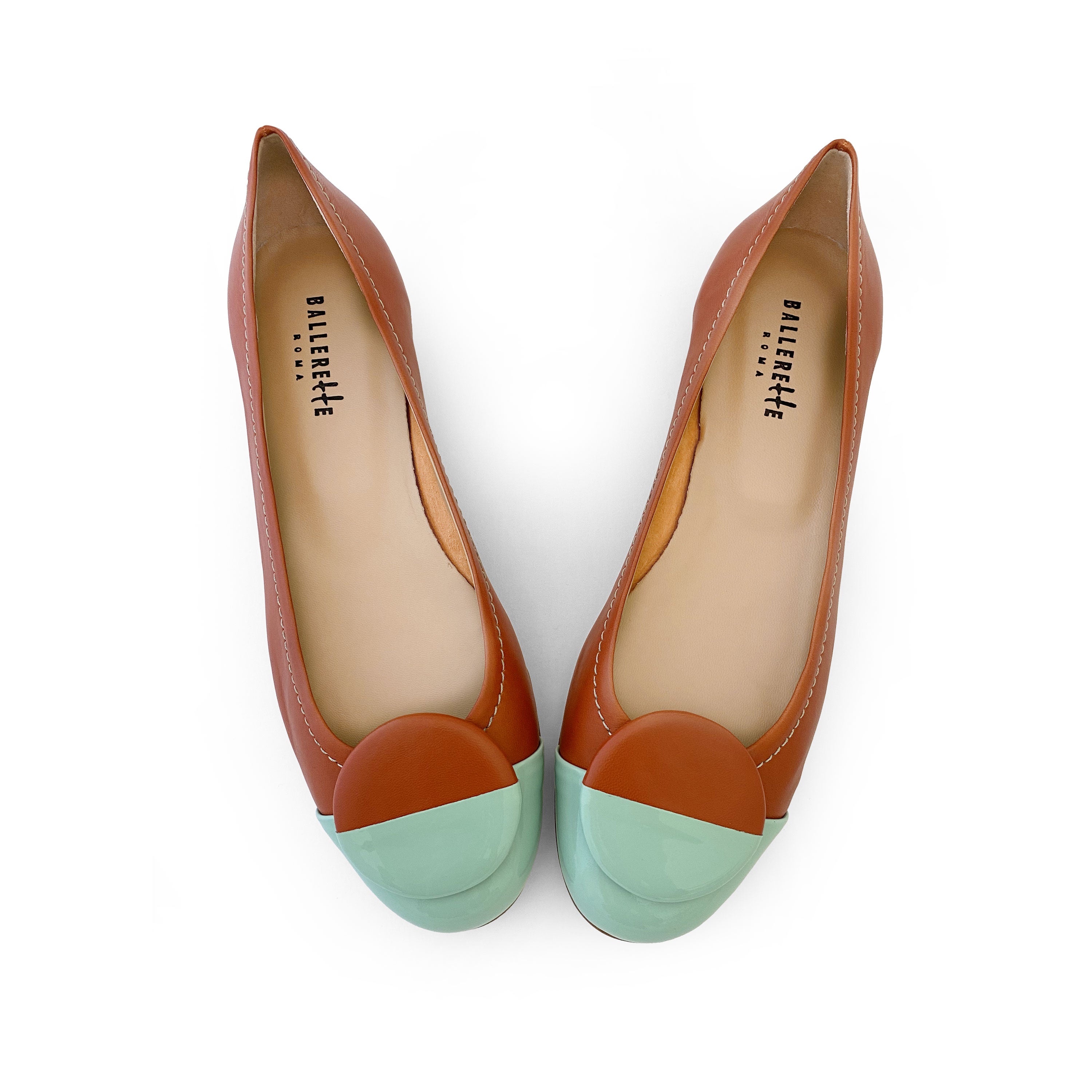 Tan leather ballet flats with green patent leather toe and stud