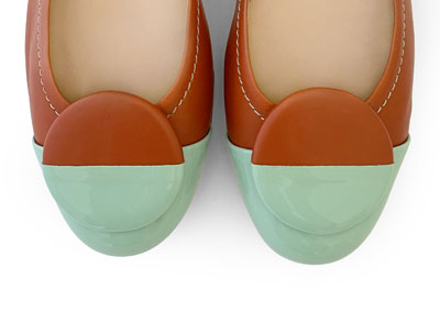 Tan leather ballet flats with green patent leather toe and stud