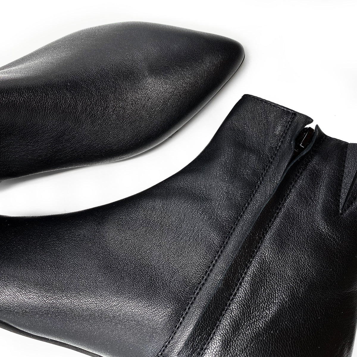 Black leather pointed-toe ankle boots with hidden internal platform