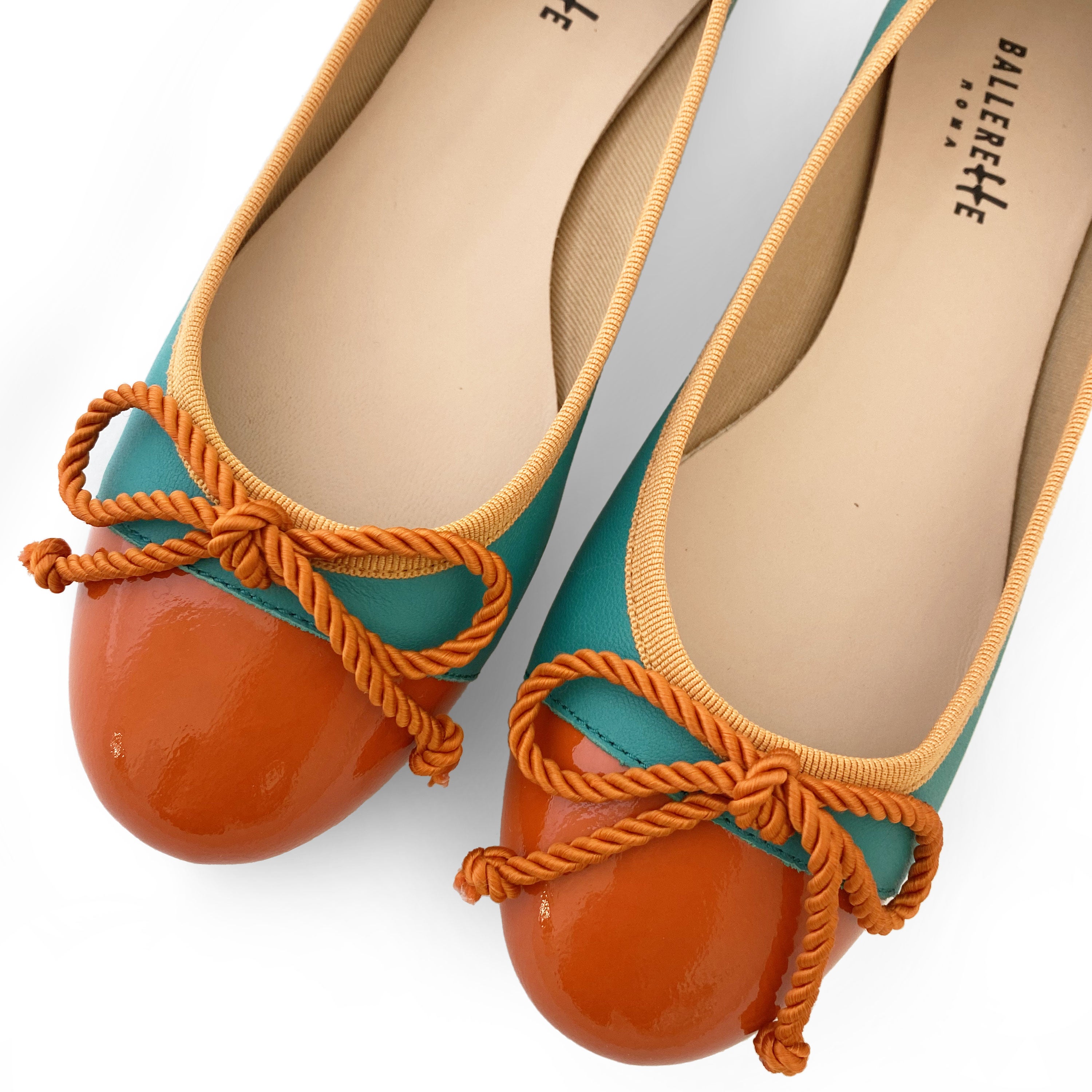 Teal leather ballet flats with orange toe and bow