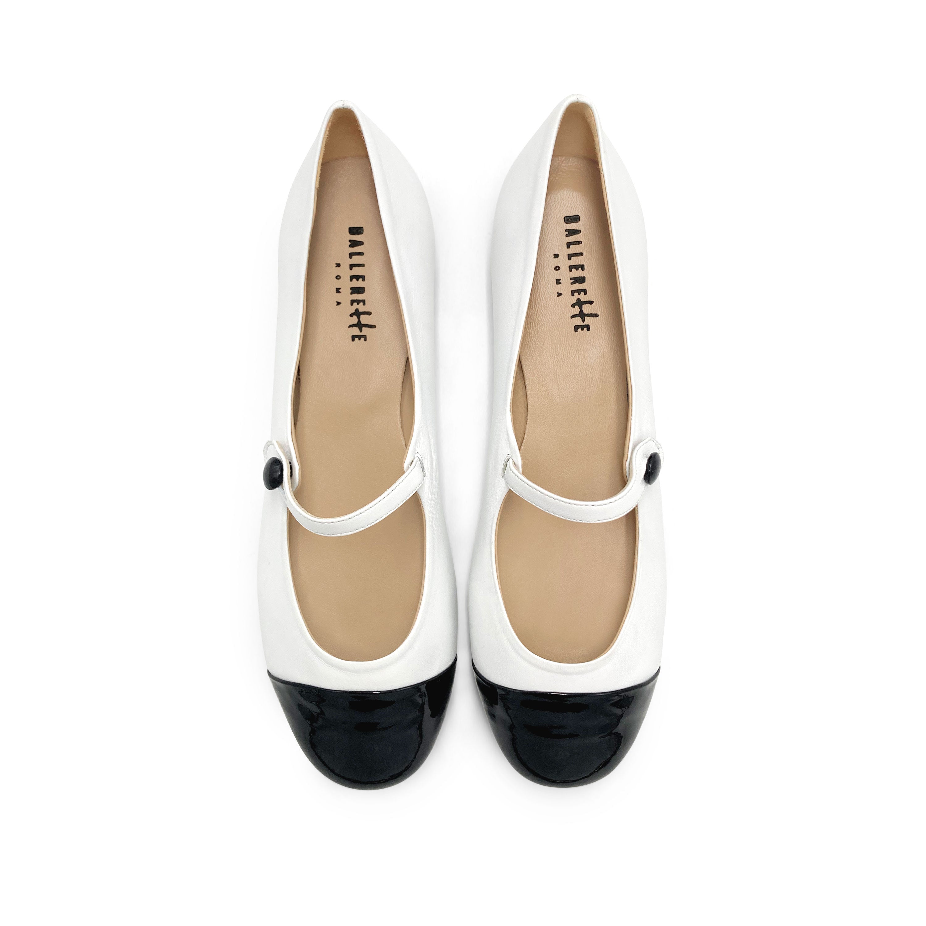 White ballet flats with black patent toe and strap