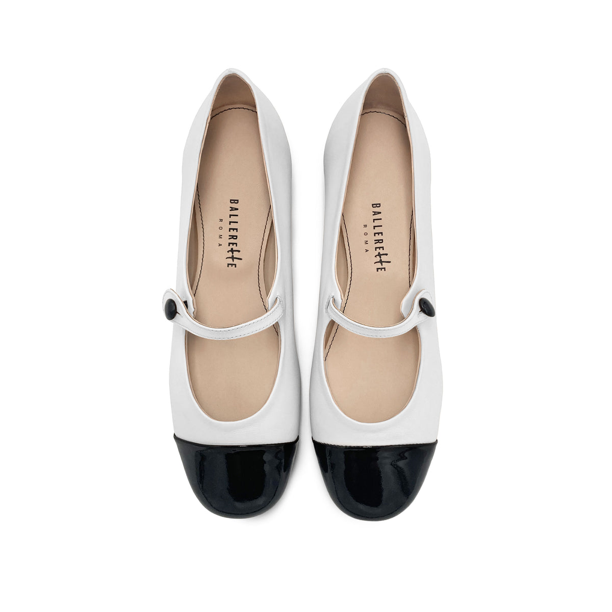 White ballet flats with black patent toe and strap