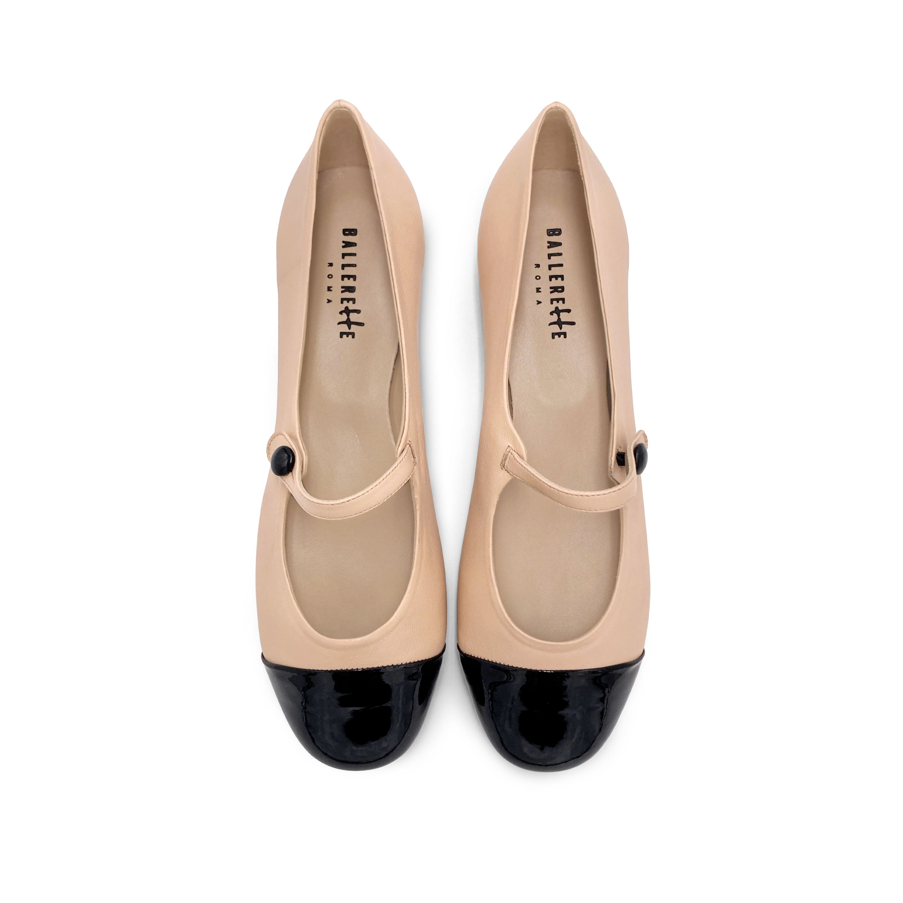 Powder pink ballet flats with black patent toe and strap