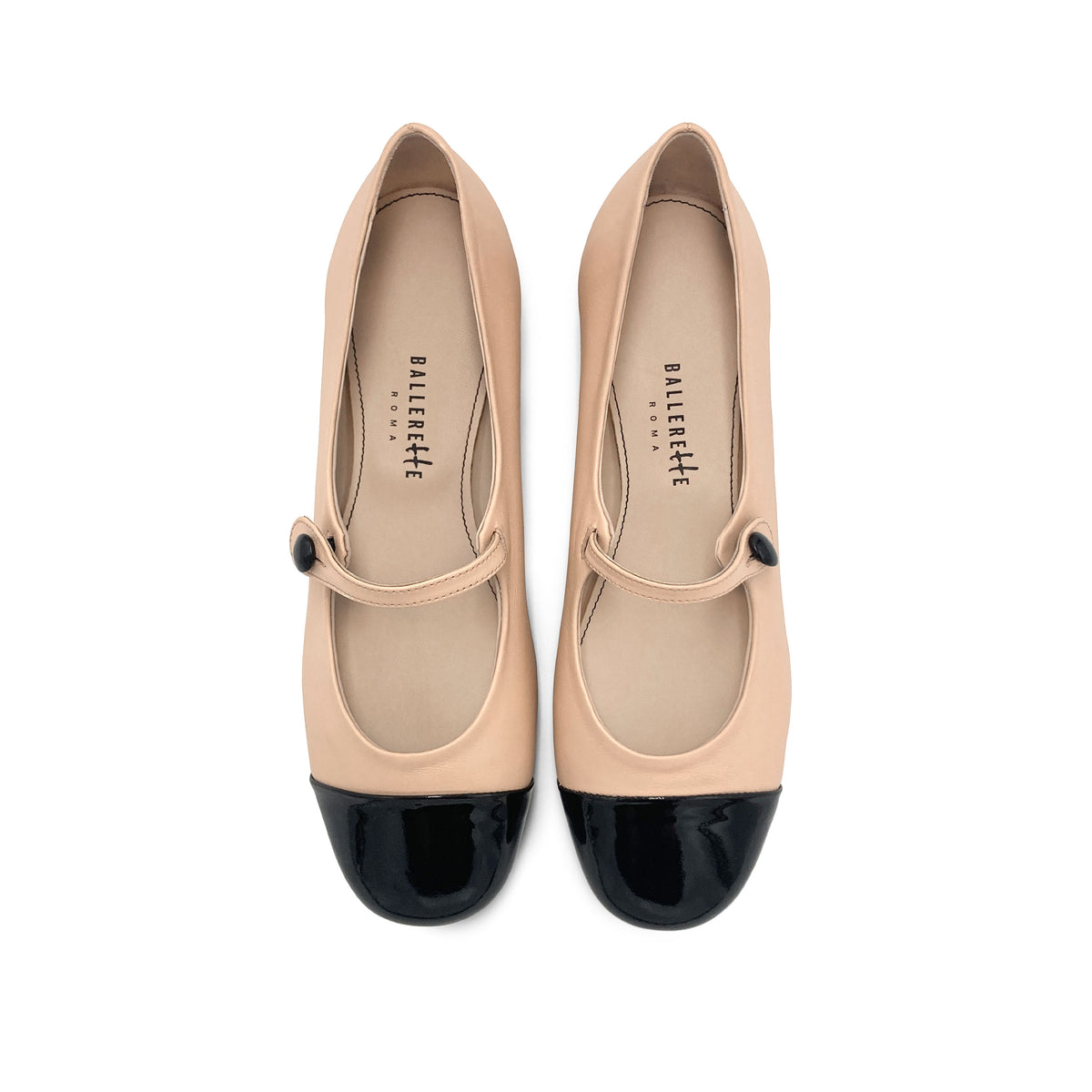 Powder pink ballet flats with black patent toe and strap
