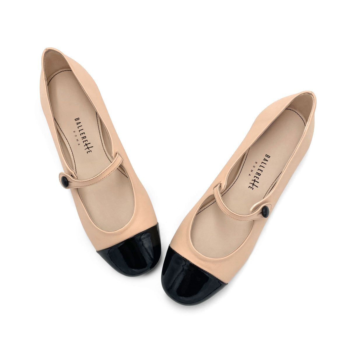 Powder pink ballet flats with black patent toe and strap