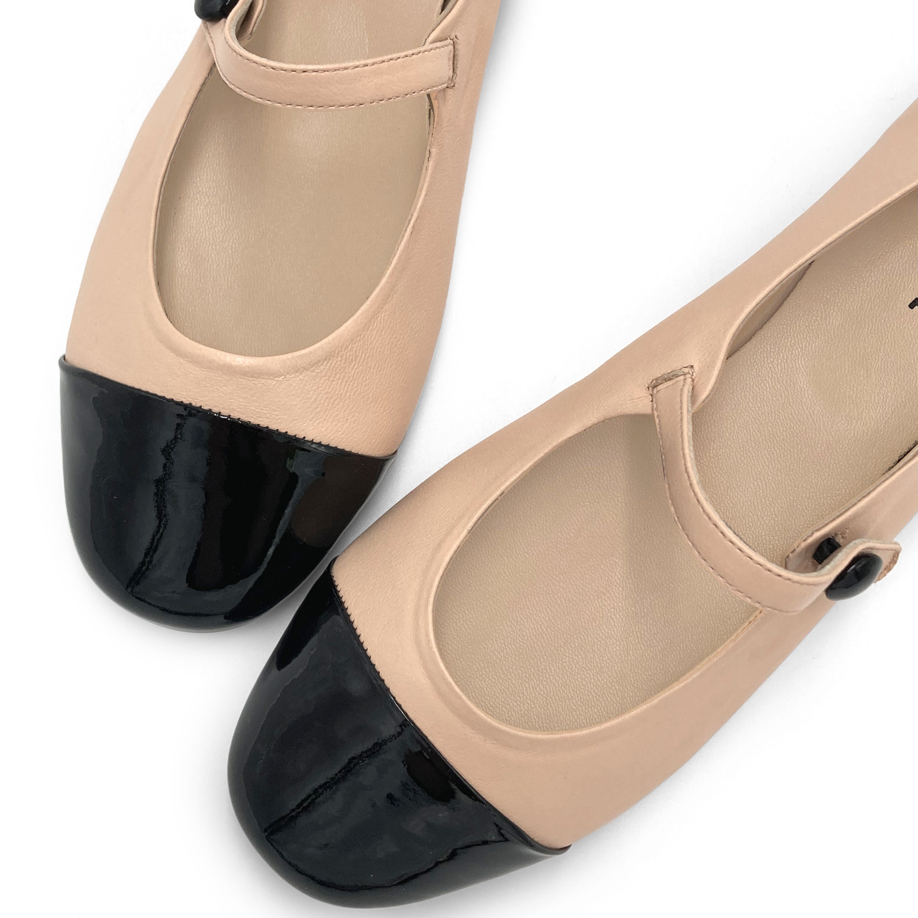 Powder pink ballet flats with black patent toe and strap