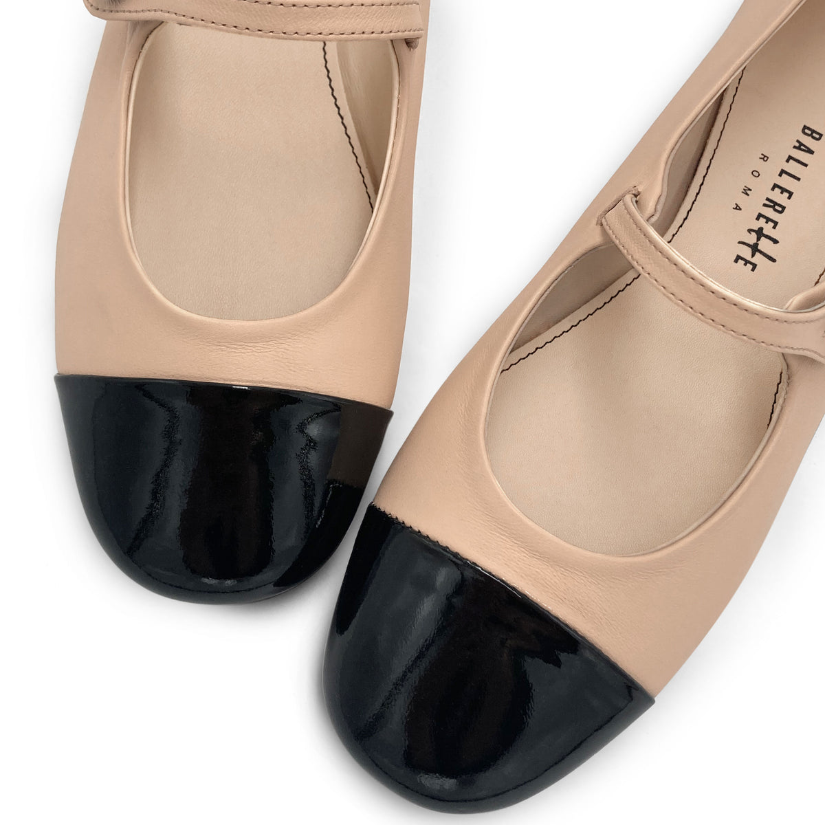 Powder pink ballet flats with black patent toe and strap