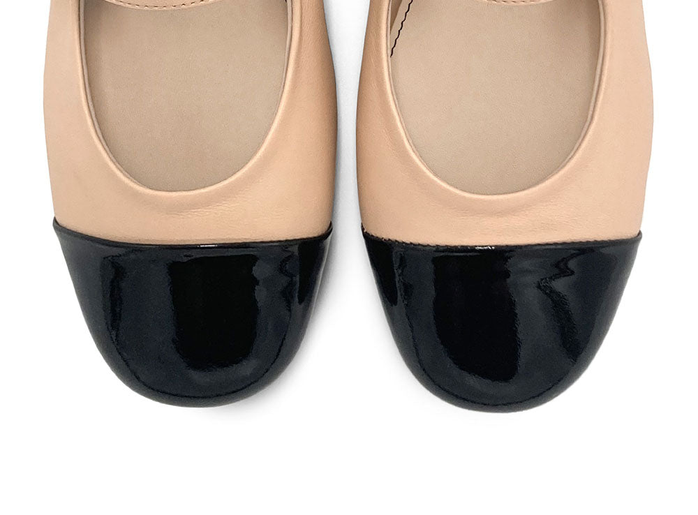 Powder pink ballet flats with black patent toe and strap