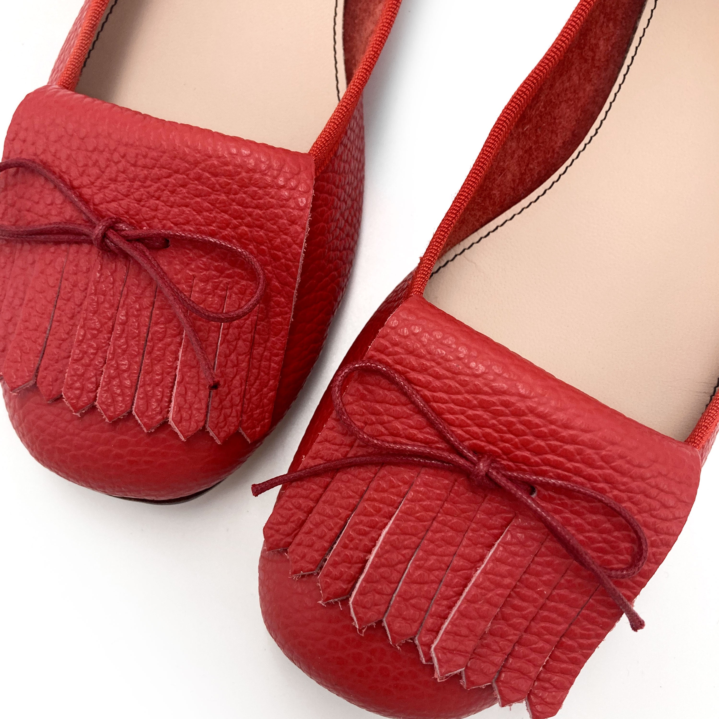 Women's strawberry red leather moccasins with fringes
