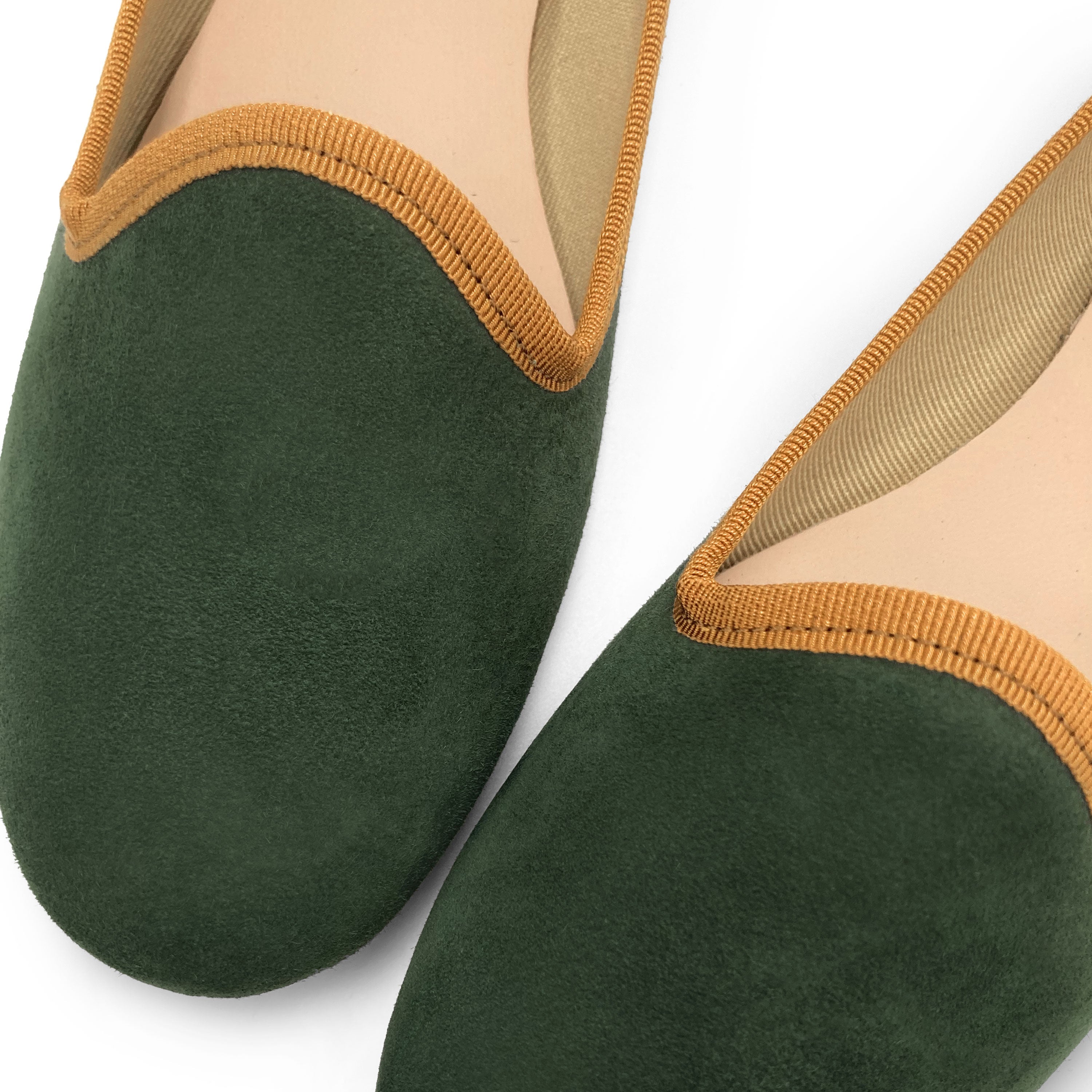 Forest green suede loafers with amber yellow details