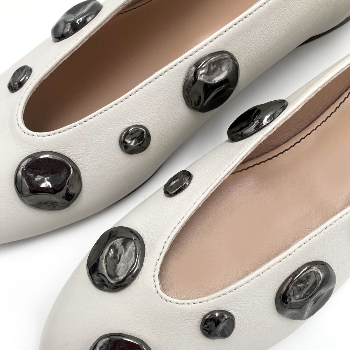 Ivory white leather ballet flats with V-cut and iron studs