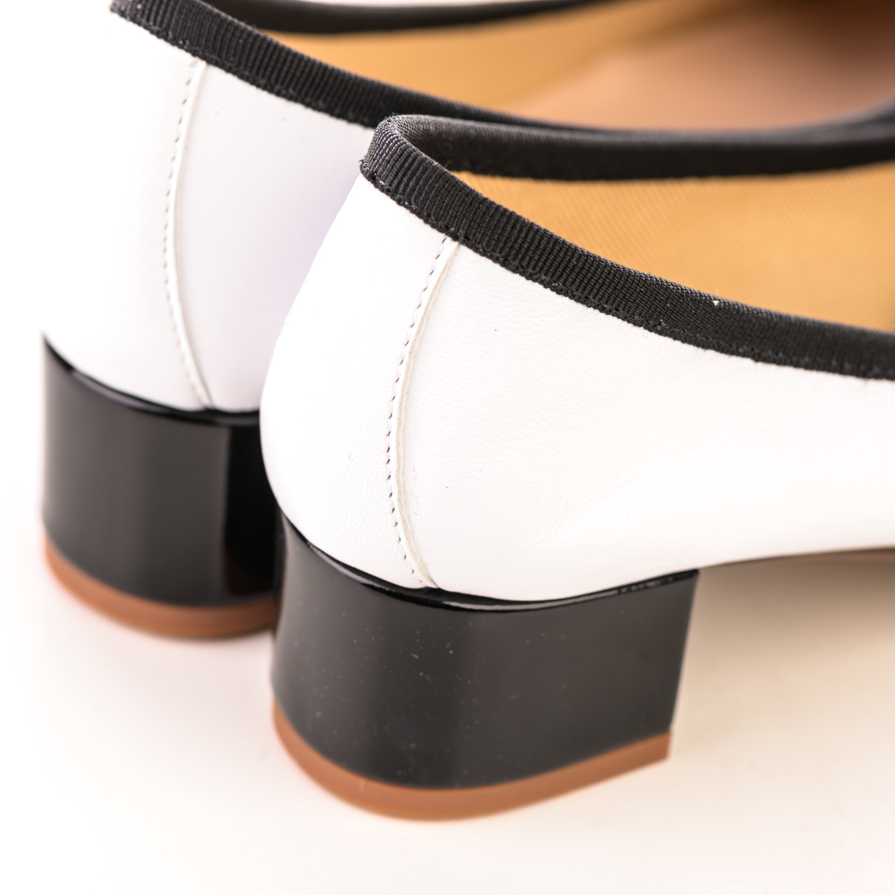 White leather ballet flats with high heel and patent toe