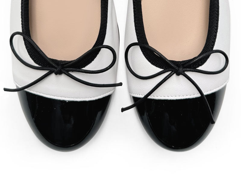 White leather ballet flats with high heel and patent toe