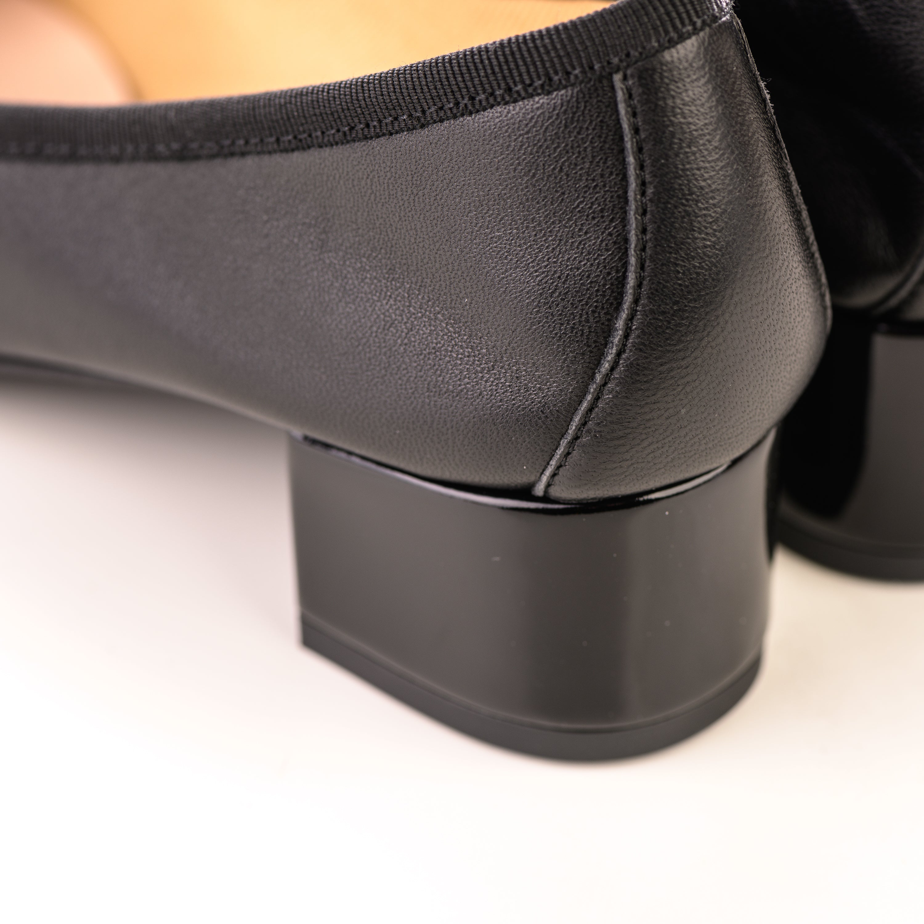 Black leather ballet flats with high heel and patent toe