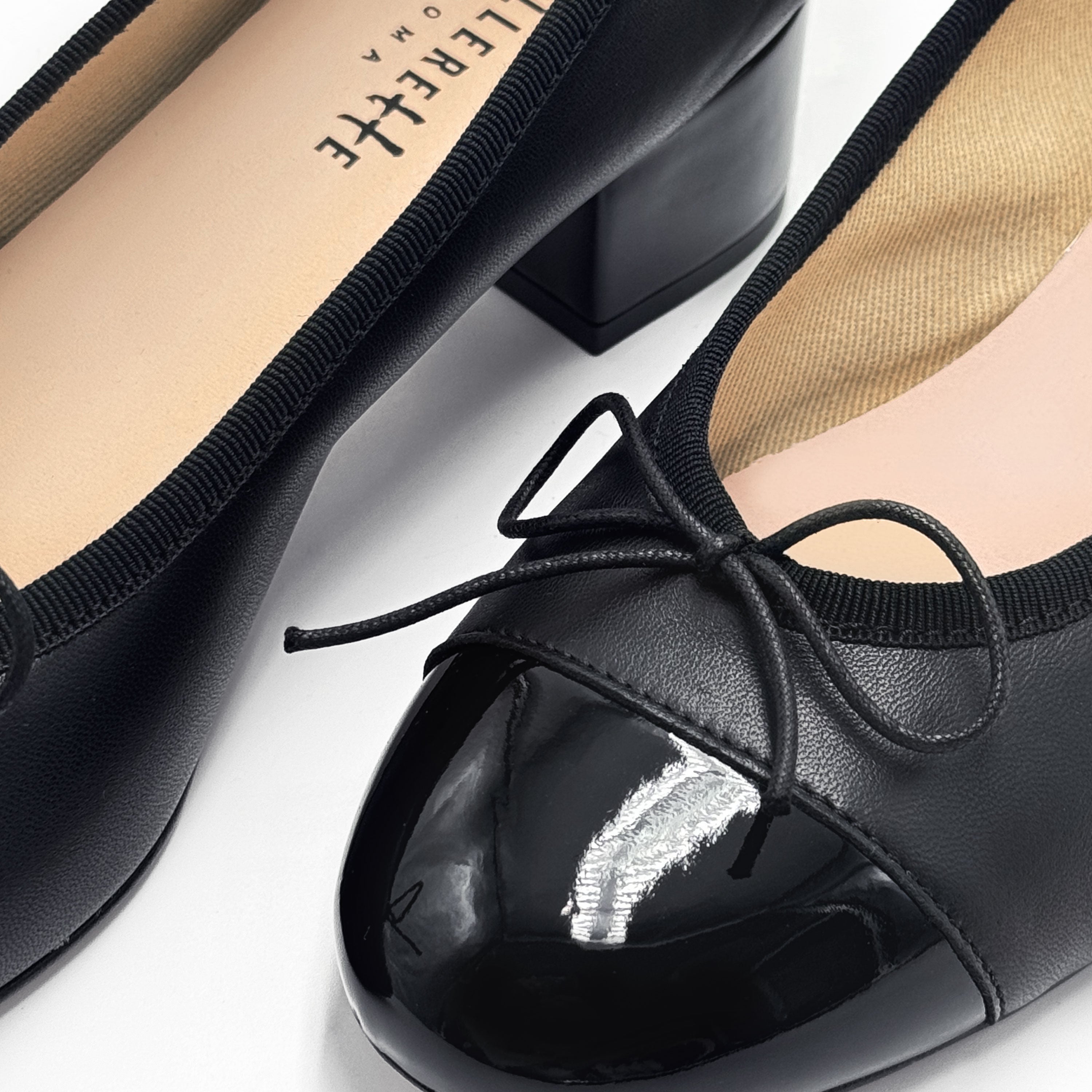 Black leather ballet flats with high heel and patent toe