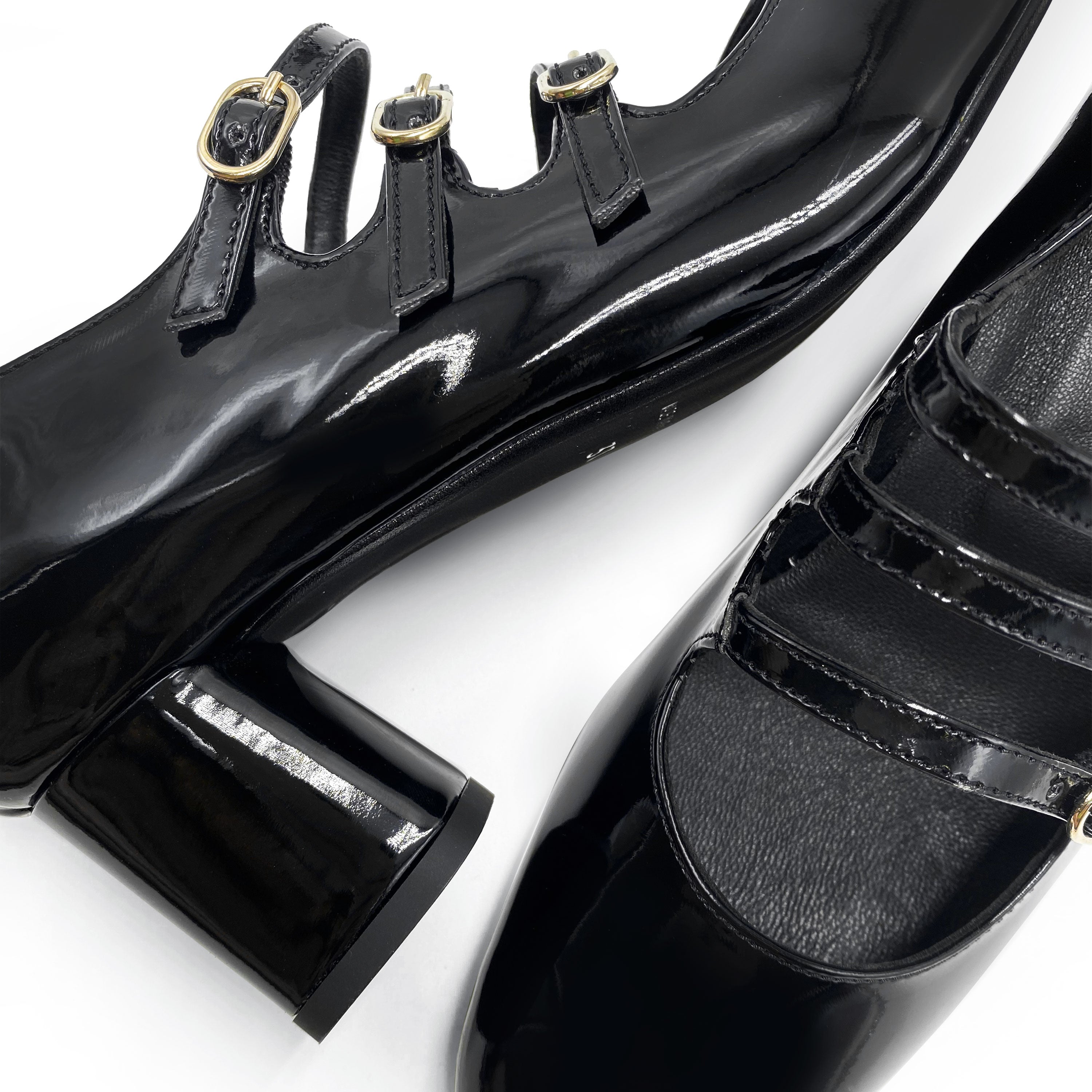 Black patent leather Mary Jane shoes with three straps and high heel