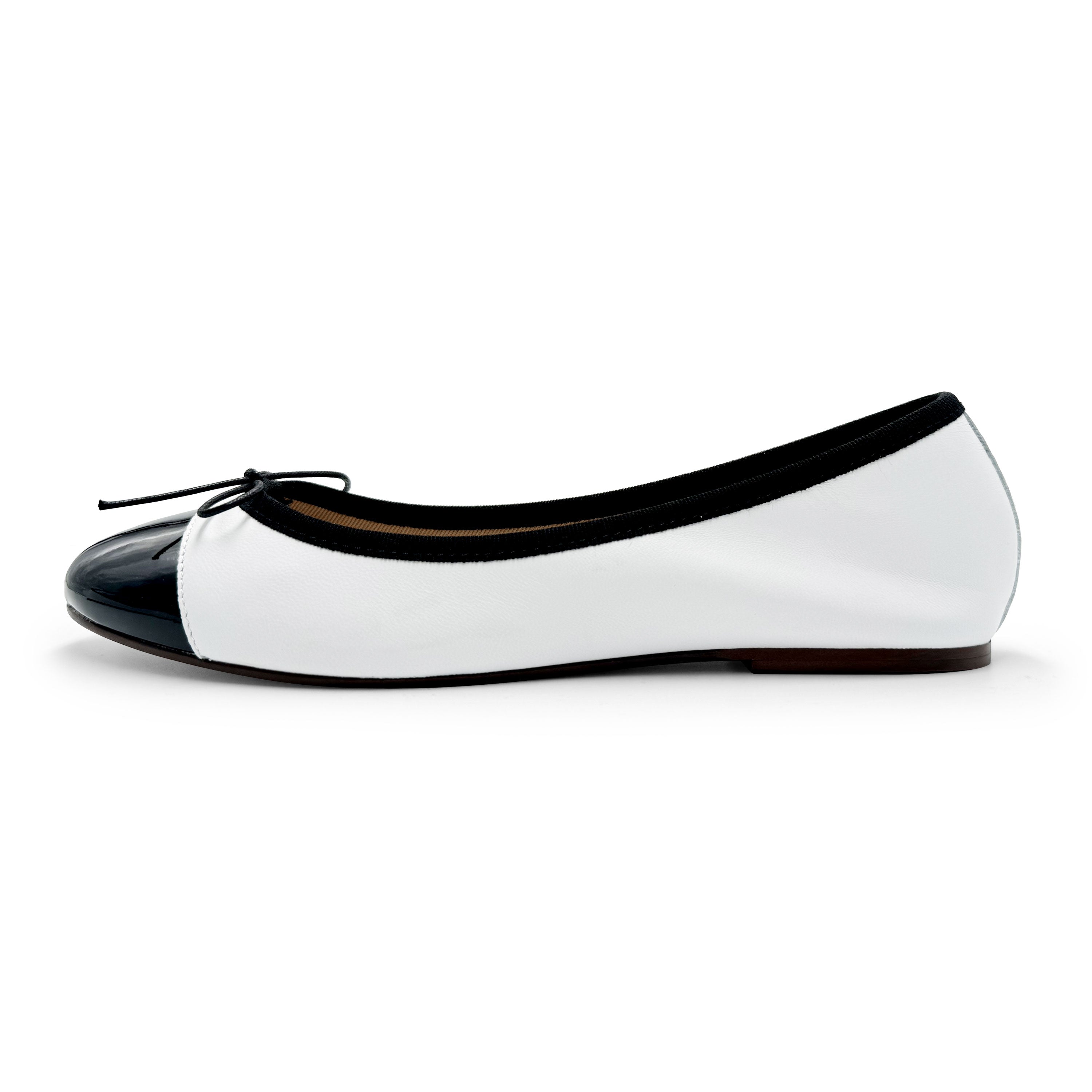 White leather ballet flats with black patent toe