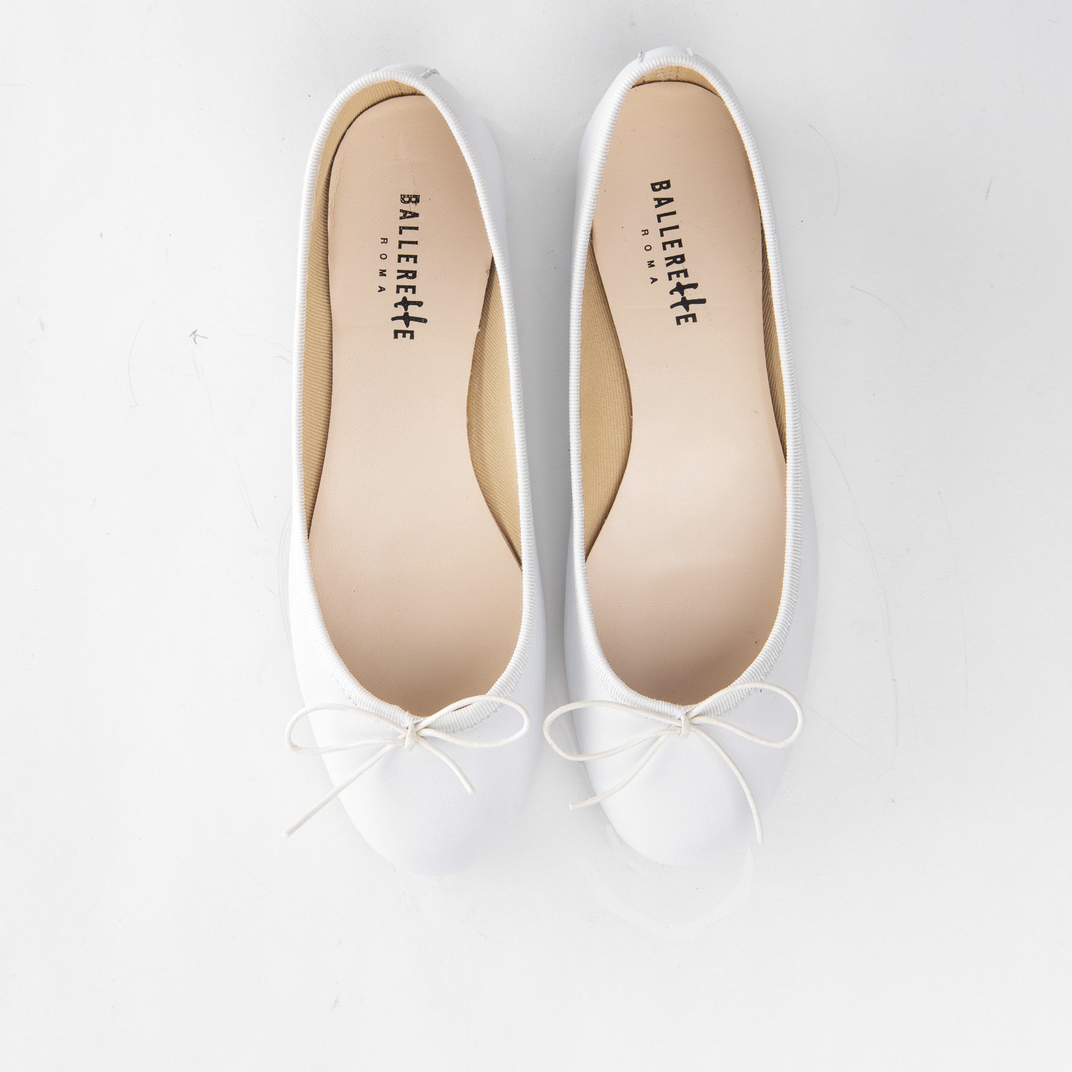 White leather ballet flats