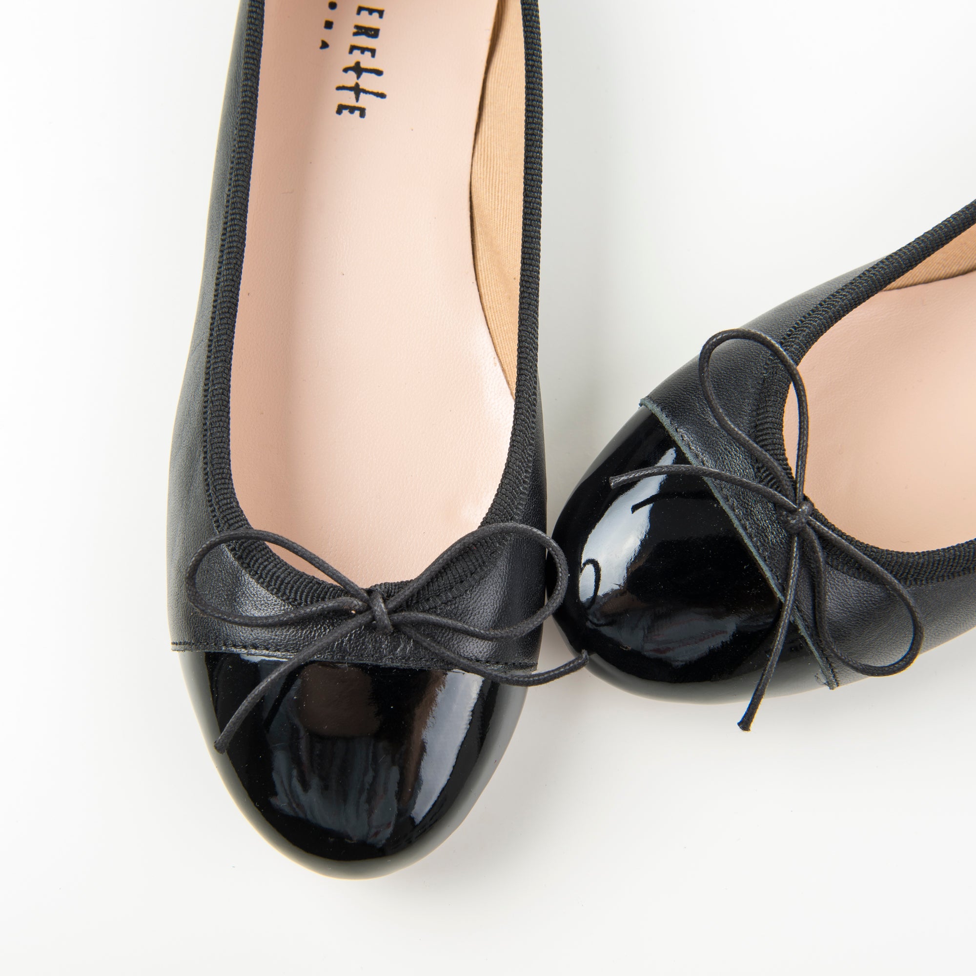 Black leather ballet flats with black patent toe