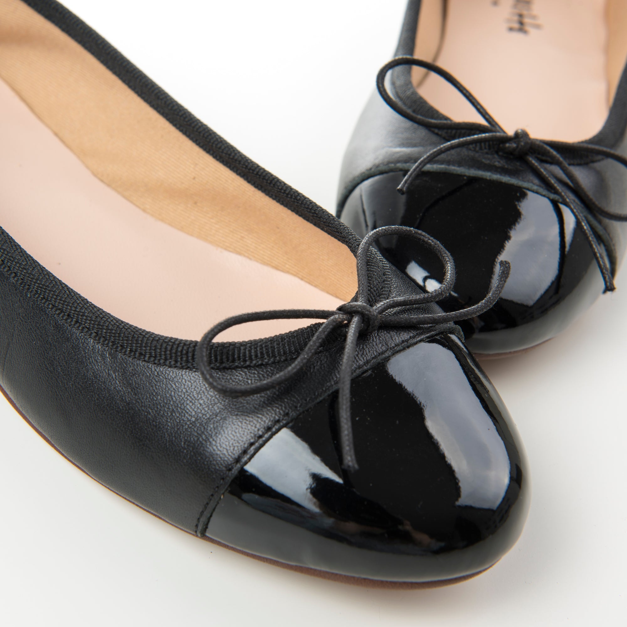 Black leather ballet flats with black patent toe