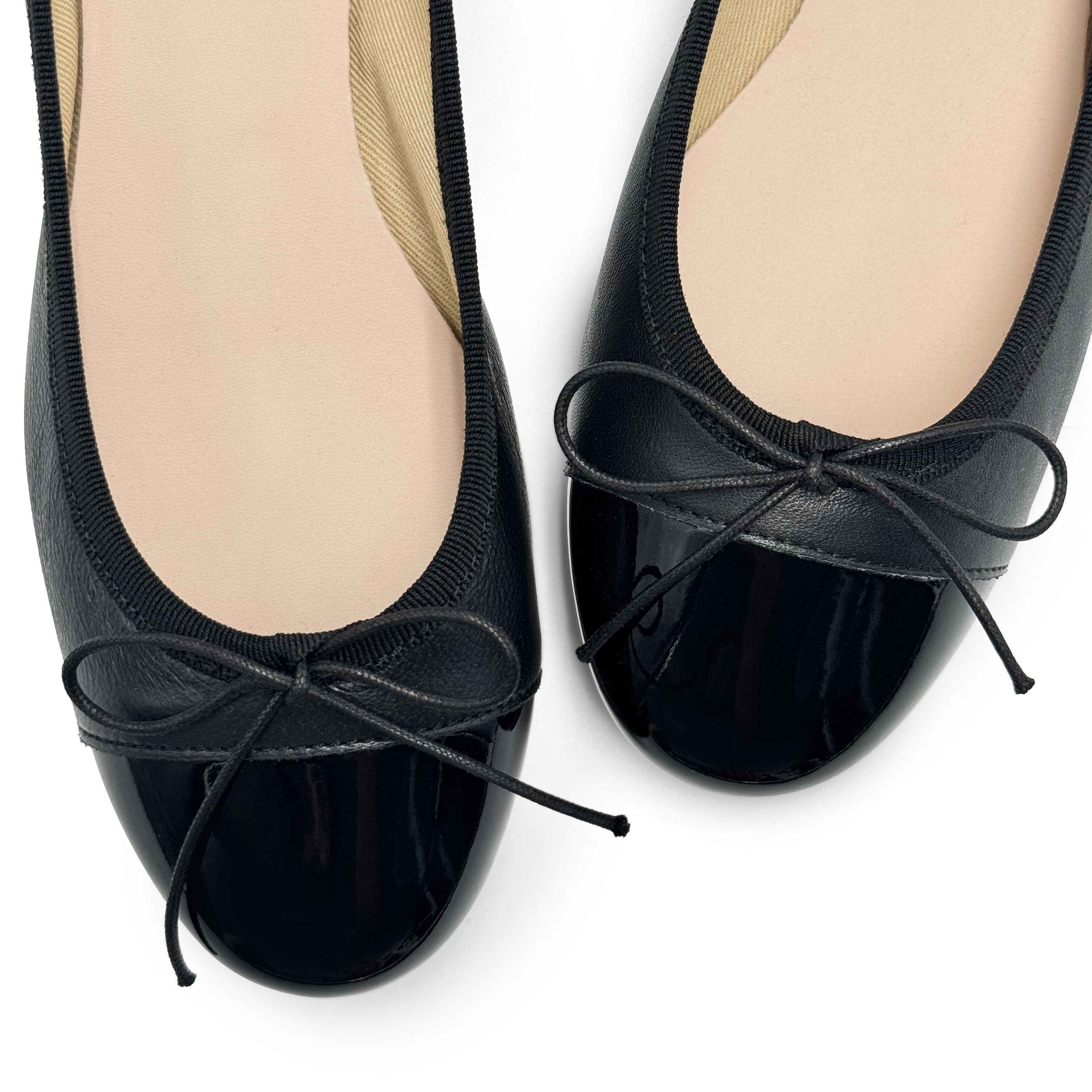 Black leather ballet flats with black patent toe