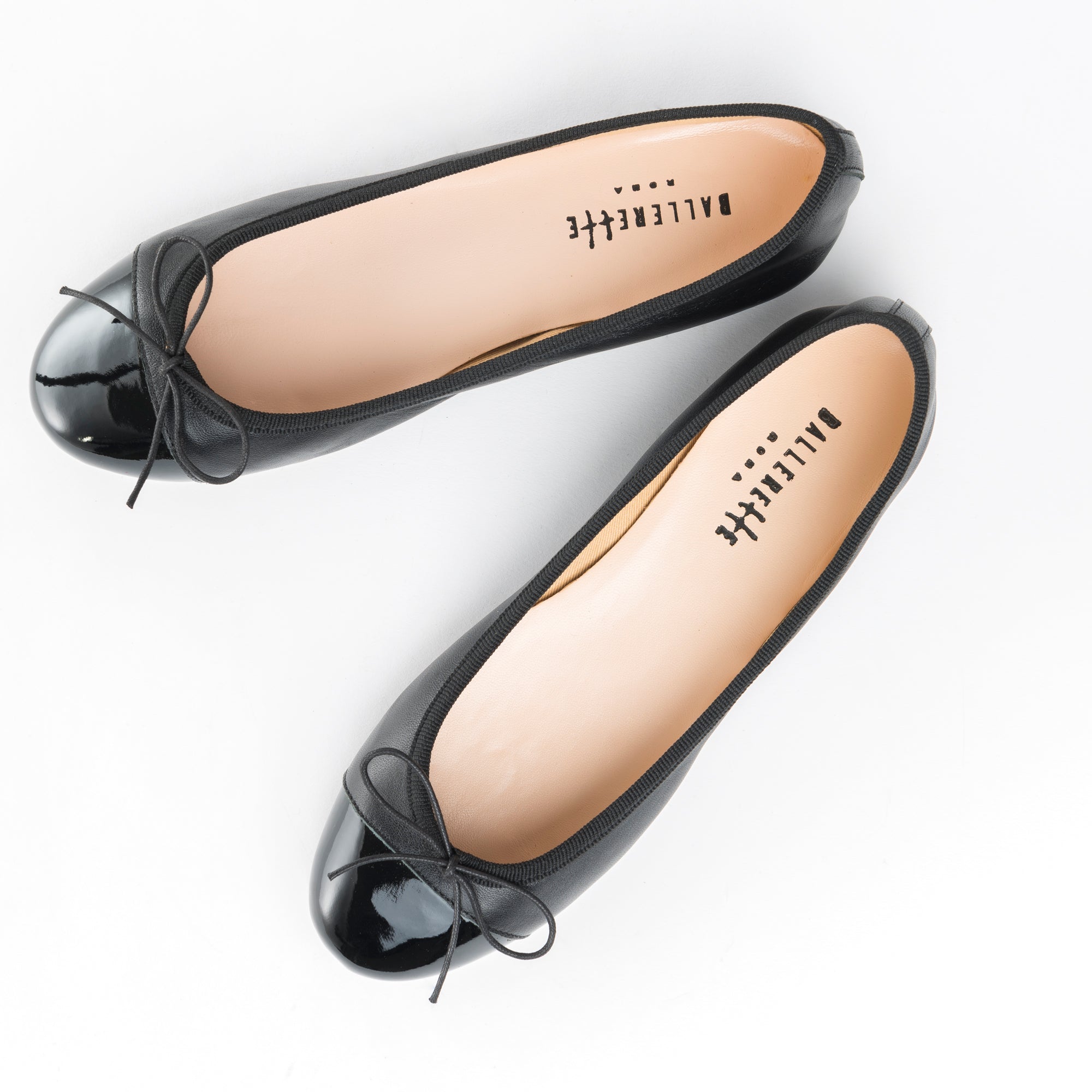 Black leather ballet flats with black patent toe