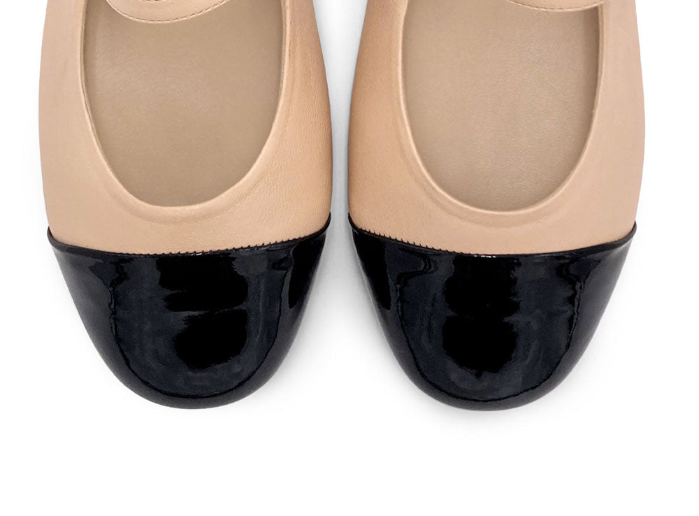 Powder pink ballet flats with black patent toe and strap
