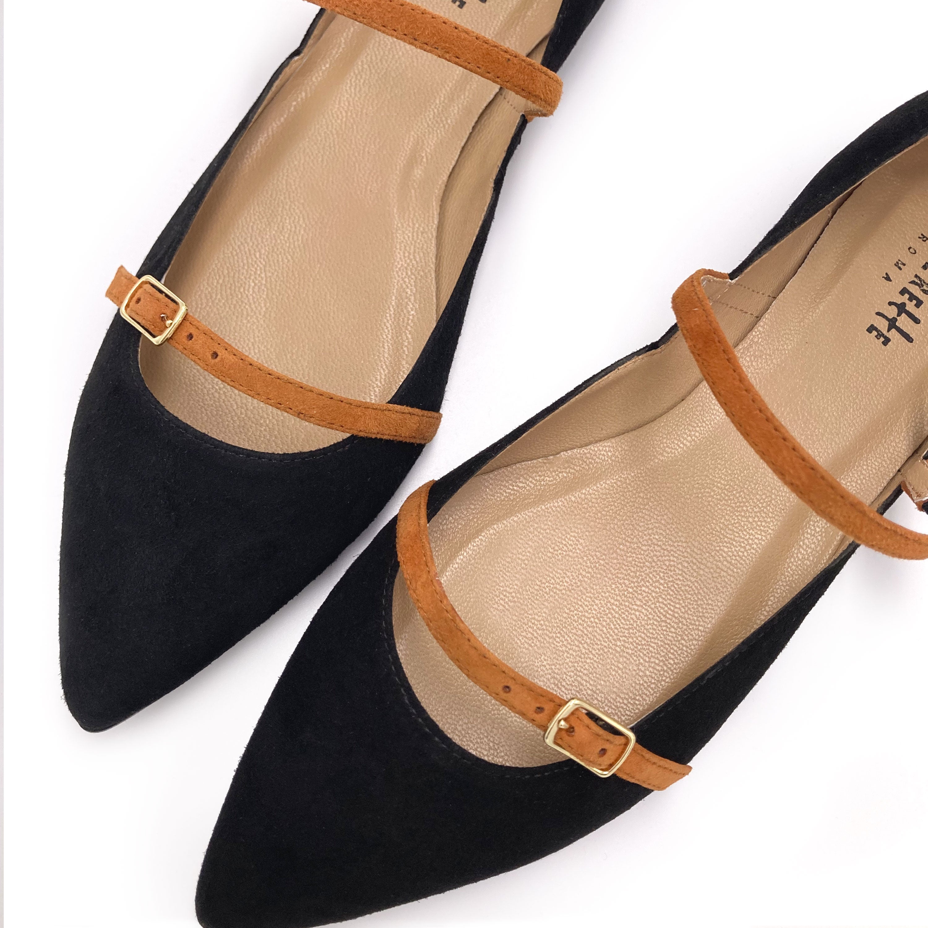 Black suede pointed ballet flats with biscuit-colored straps