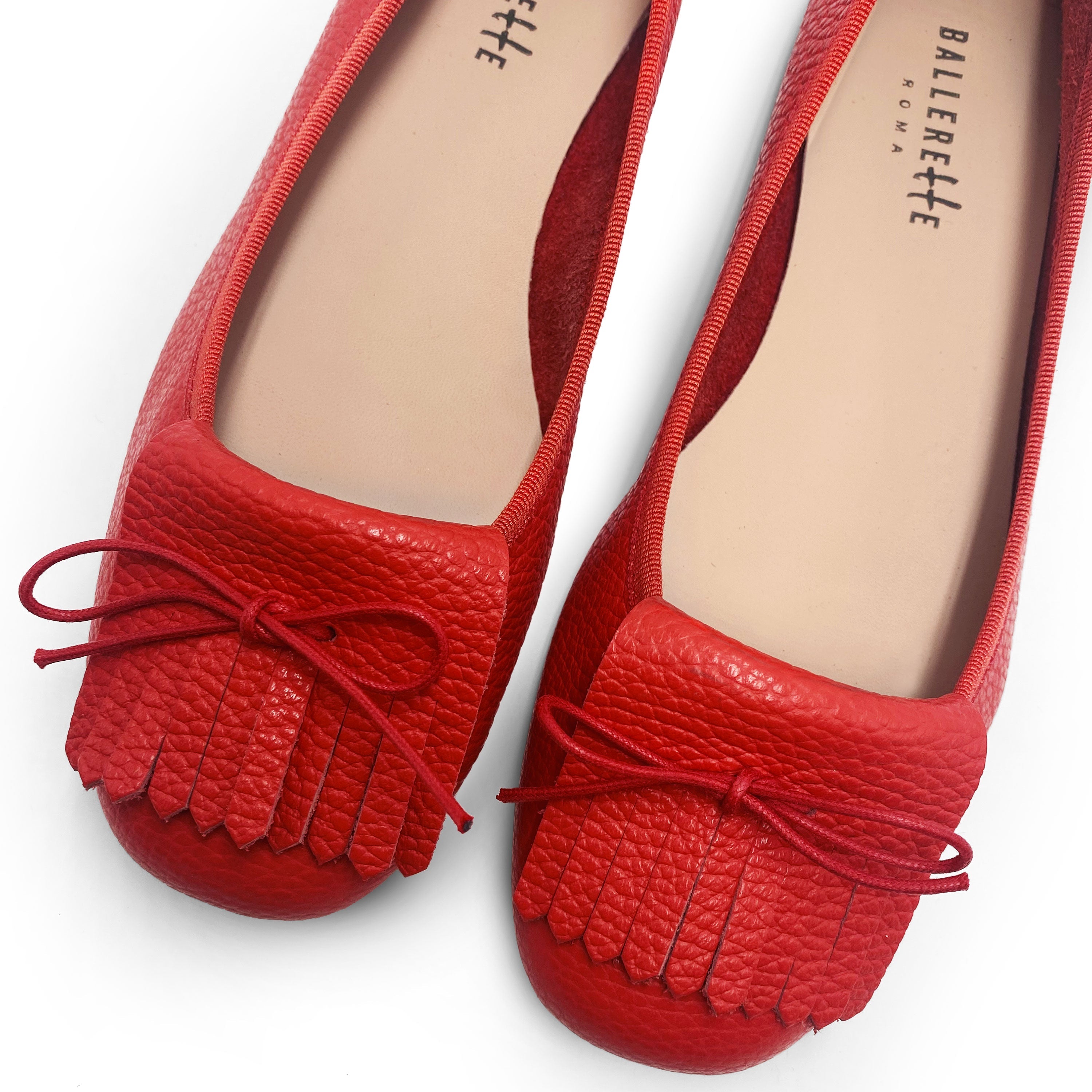 Women's strawberry red leather moccasins with fringes