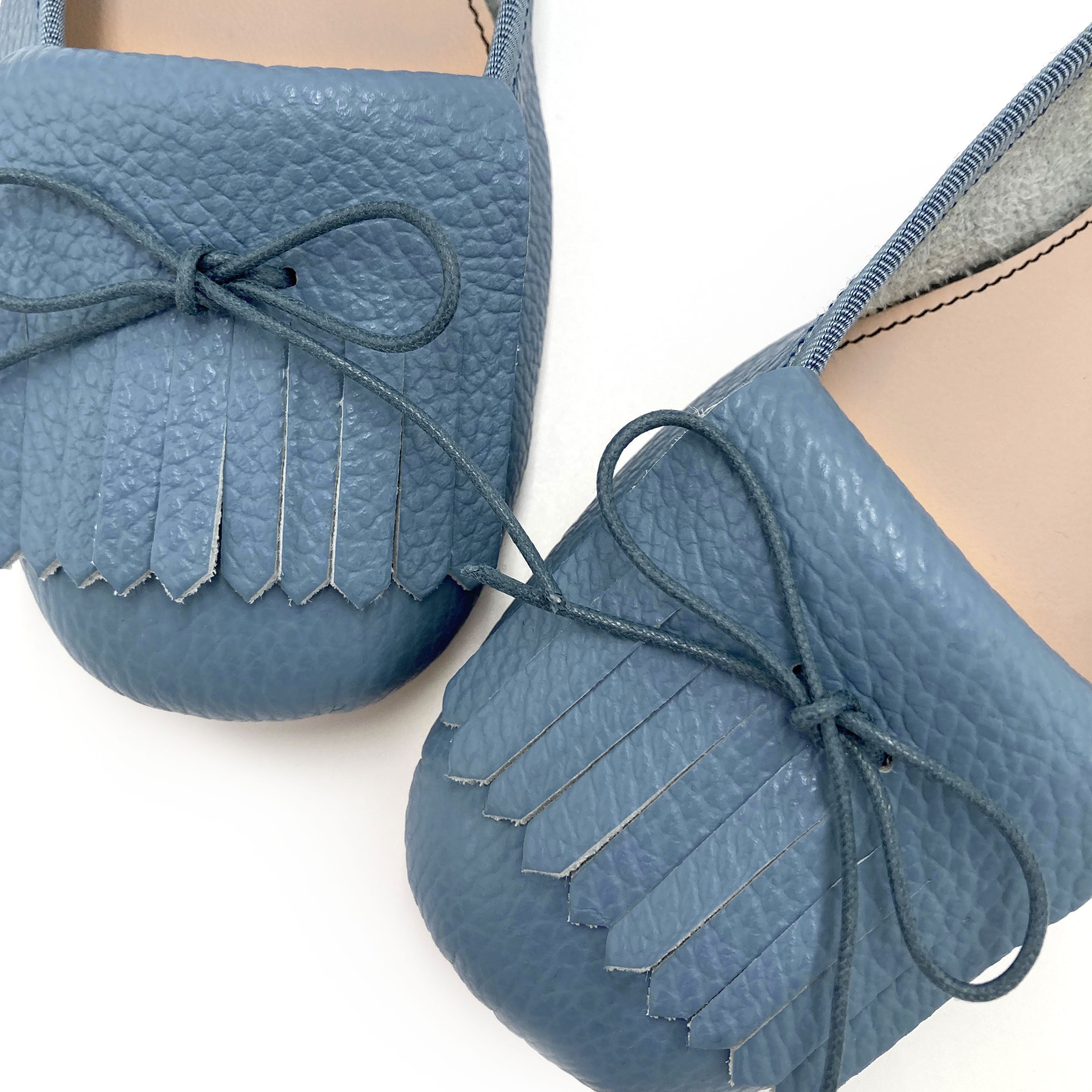 Denim-blue leather moccassins with fringes