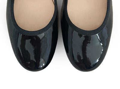 Black patent leather Mary Jane ballet flats with strap and heel