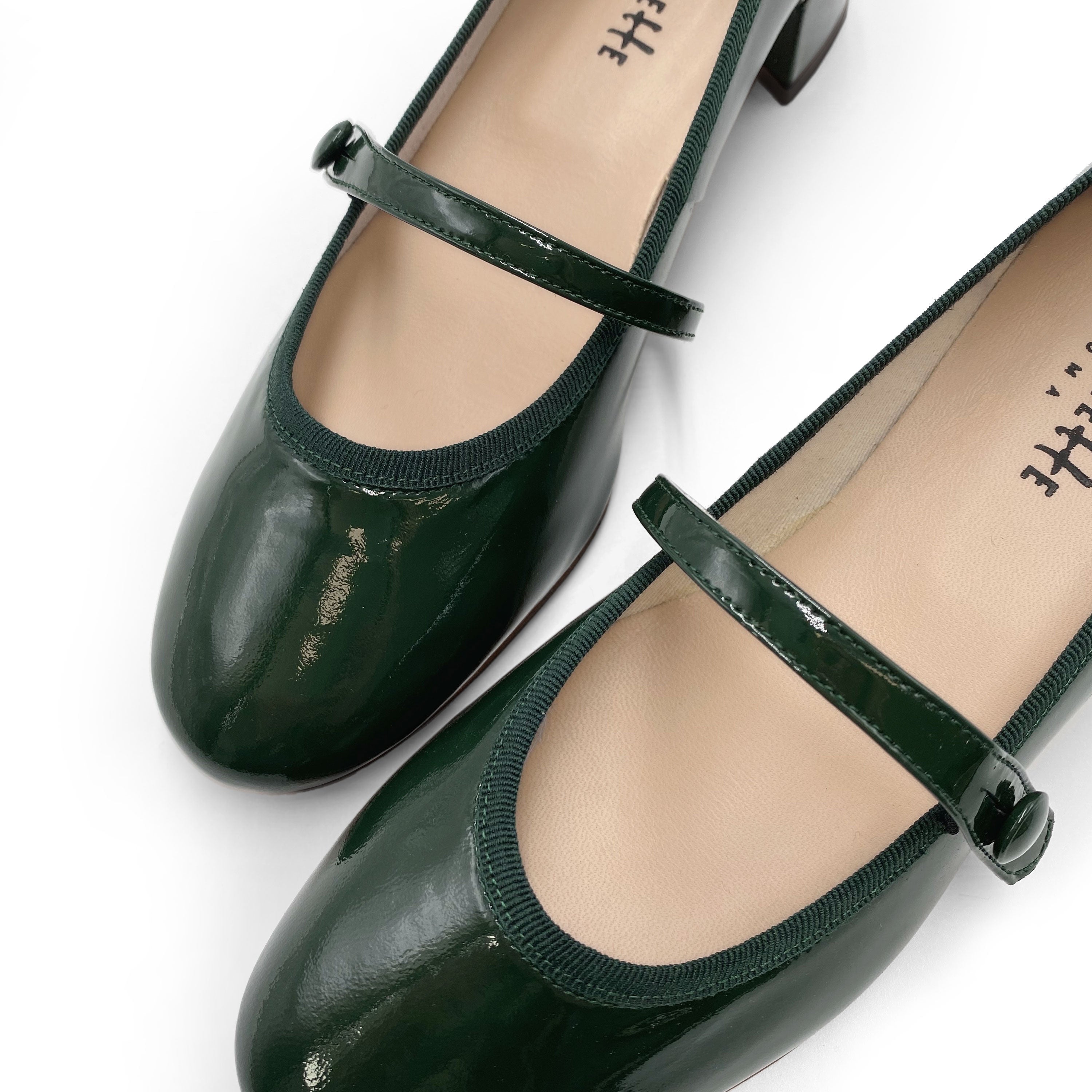 Green patent leather ballet flats with strap and heel