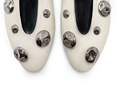 Ivory white leather ballet flats with V-cut and iron studs